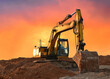 Excavator working on earthmoving at open pit mining on amazing sunset background. Backhoe digs sand and gravel in quarry. Heavy construction equipment during excavation at construction site