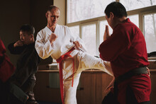  A Man In A Red Belt Teaches A Guy In A Kimono.