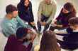 © Studio Romantic - Diverse people sitting in circle and sharing their stories in group therapy session
