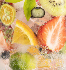 Vertical closeup shot of fruits and berries in sparkling water