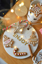 Decorated Gingerbreads On A Marble Tray And Christmas Lollipop