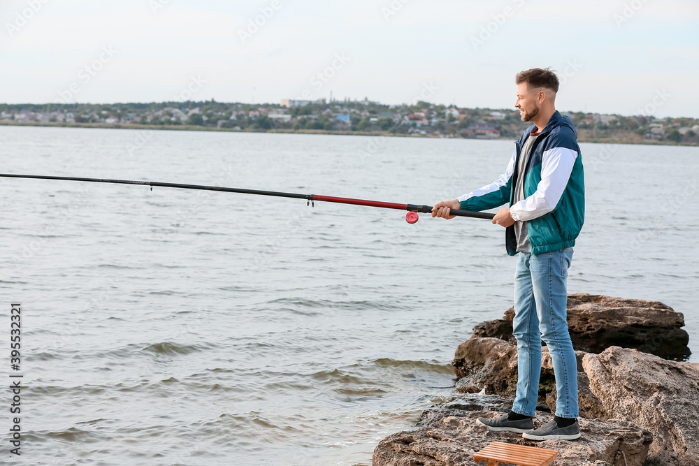 Young man fishing on river