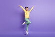 © deagreez - Full size photo of optimistic cute girl jump wear yellow shirt trousers sneakers isolated on lilac color background