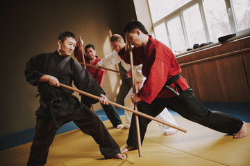 Wall Mural - Man strikes an opponent while training.