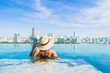 © siraphol - Portrait beautiful young asian woman smile relax leisure around outdoor swimming pool