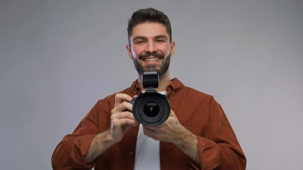 Wall Mural - photography, profession and people and concept - video portrait of happy smiling man or photographer with digital camera over grey background