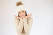 © Danko - Close up of a smiling young woman in casual sweater isolated over white background