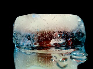 piece of ice glowing in the dark in abstract macro photography