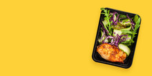 Healthy meal prep containers with  chicken and vegetable salad. Yellow background. Top view