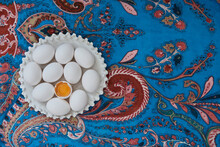 White Eggs On A Blue Tablecloth With A Floral Pattern