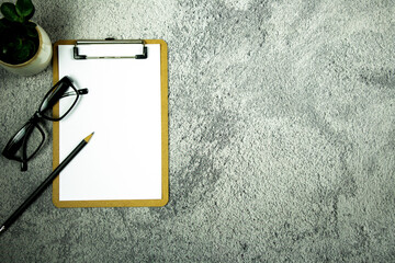 Wall Mural - A notebook with pencil and eye glasses on the desk. - Business concept.