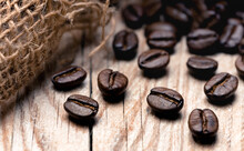 Roasted Coffee Beans On A Wooden Surface (close-up)