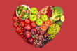 © Foodlovers - Various vegetables, fruit, nuts in heart shape on red background with clipping path