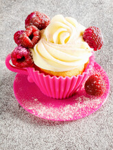 Cupcake With Butter Cream Rose And Raspberries