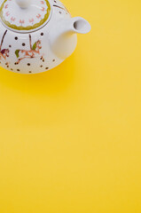 Sticker - Vertical shot of teapot isolated on yellow background