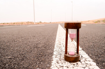 Poster - Closeup shot of an hourglass on a street