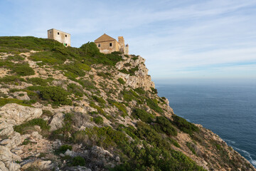 Ruin buildings in Cape Espichel landscape with atlantic ocean and cliffs, in Portugal