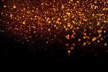 Beautiful, Sparkling Orange Glitter Pouring Down From Above On A Dark Background