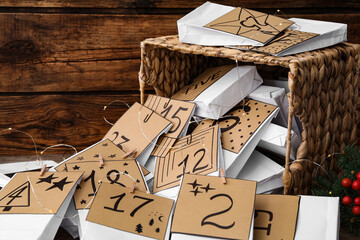 Wall Mural - Paper bags and garland on wooden background, closeup. Christmas advent calendar