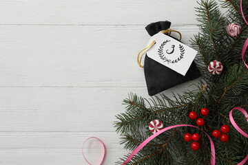 Sticker - Bag with gift, festive decor and space for text on white wooden table, flat lay. Christmas advent calendar