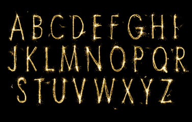Wall Mural - Set with letters made of sparkler on black background