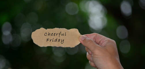Wall Mural - Cheerful Friday Text On Hands Holding Torn Paper With Blurred Dark Background
