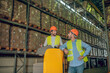 © zinkevych - Two men in orange helmets standing near shelves and talking