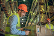 © zinkevych - Male warehouse worker in helmet scanning barcodes on the boxes