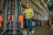 © zinkevych - Young male worker in yellow vest and jeans standing near shelves