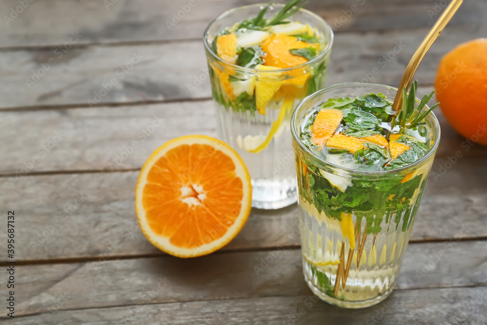 Glasses of citrus mojito on wooden table