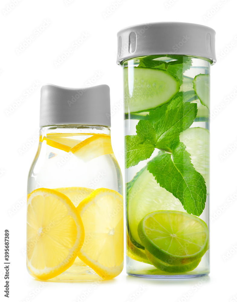 Bottles of clean water with mint, lemon and lime on white background