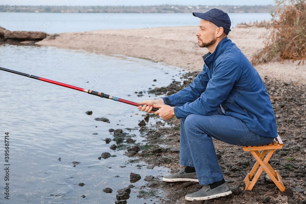 Young man fishing on river