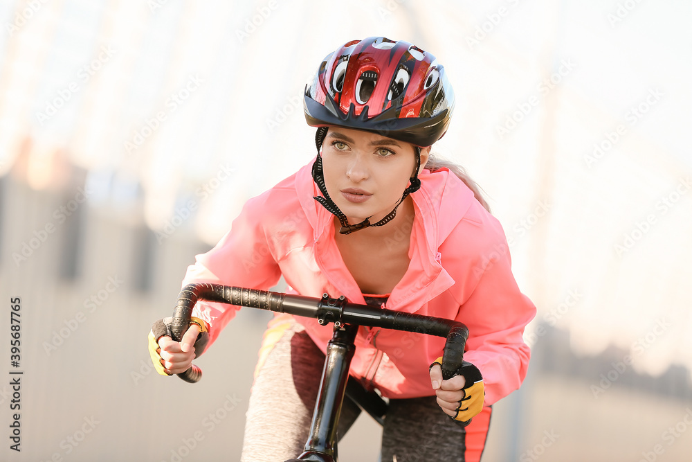 Female cyclist riding bicycle outdoors
