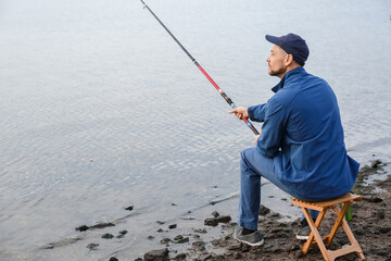 Poster - Young man fishing on river