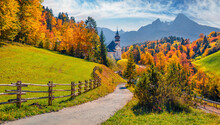 Iconic Picture Of Bavaria With Maria Gern Church With Hochkalter Peak On Background. Sunny Autumn Scene Of Alps. Beautiful Landscape Of Germany Countryside. Beautiful Autumn Scenery.