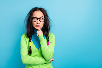 Canvas Print - Photo of minded serious focused young schoolgirl hold hand chin look empty space isolated on blue color background