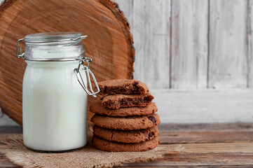 milk and cookies on a wooden table