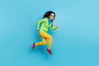 © deagreez - Full length profile side photo of funky trendy young woman run jump up air copyspace isolated on shine blue color background