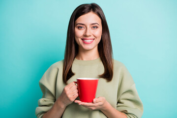 Poster - Photo portrait of positive woman drinking tea on break holding red mug isolated on vivid cyan colored background