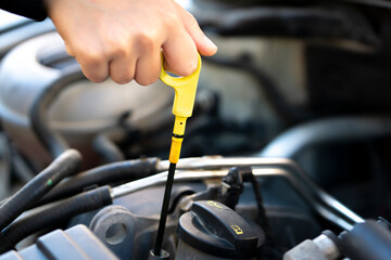 to check car engine oil, using engine oil check stick