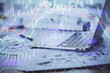 © peshkova - Stock market graph on background with desk and personal computer. Double exposure. Concept of financial analysis.