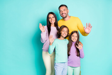 Photo portrait of full family with small kids waving hands saying hi isolated on vivid cyan colored background