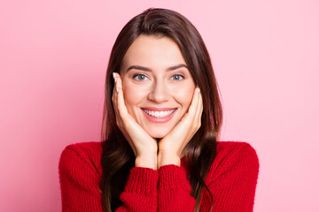 Poster - Closeup headshot photo portrait of cute pretty young girl touching cheeks with both hands smiling wearing red sweater isolated on pink color background