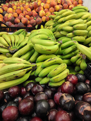 Wall Mural - vertical shot of unripe bananas peaches and plums