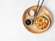 Udon noodles with seafood and vegetables cooked in a wok