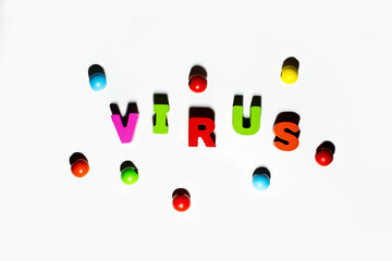  Word Virus with beads spread from colorful wooden letters at white background with shadows, health care, medical, infection, pandemic concept 