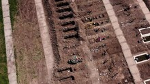 Open Graves Near A City Drone View