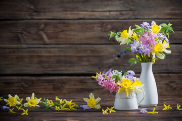 beautiful spring flowers on dark old wooden background