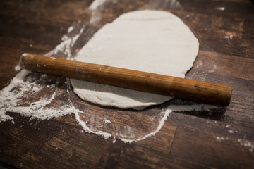 dough rolled out for pizza on the table