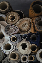 Vertical closeup shot of rolls of different fabrics